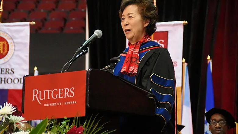 Rutgers Business School Dean Lei Lei at the podium during the Rutgers University-Newark Commencement.