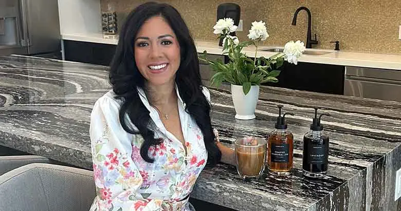 Leslie Silva posing with her product sold by Homelistic