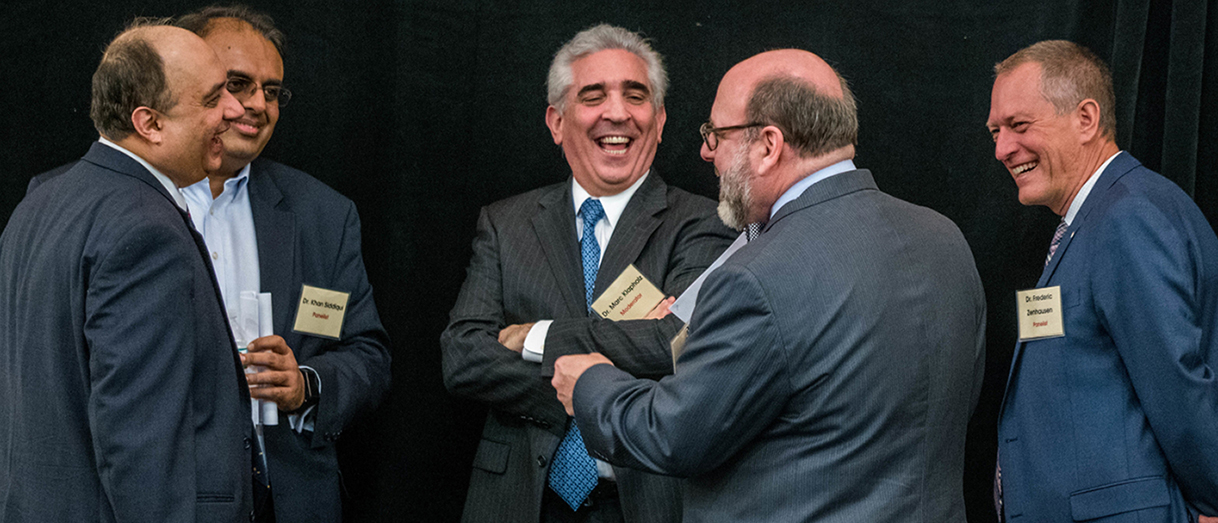 Professor Farrokh Langdana with health care professionals, including several Executive MBA alumni, during a March 15 symposium.