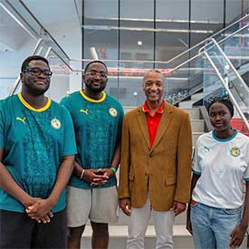 The Diop siblings stand with President Tate.