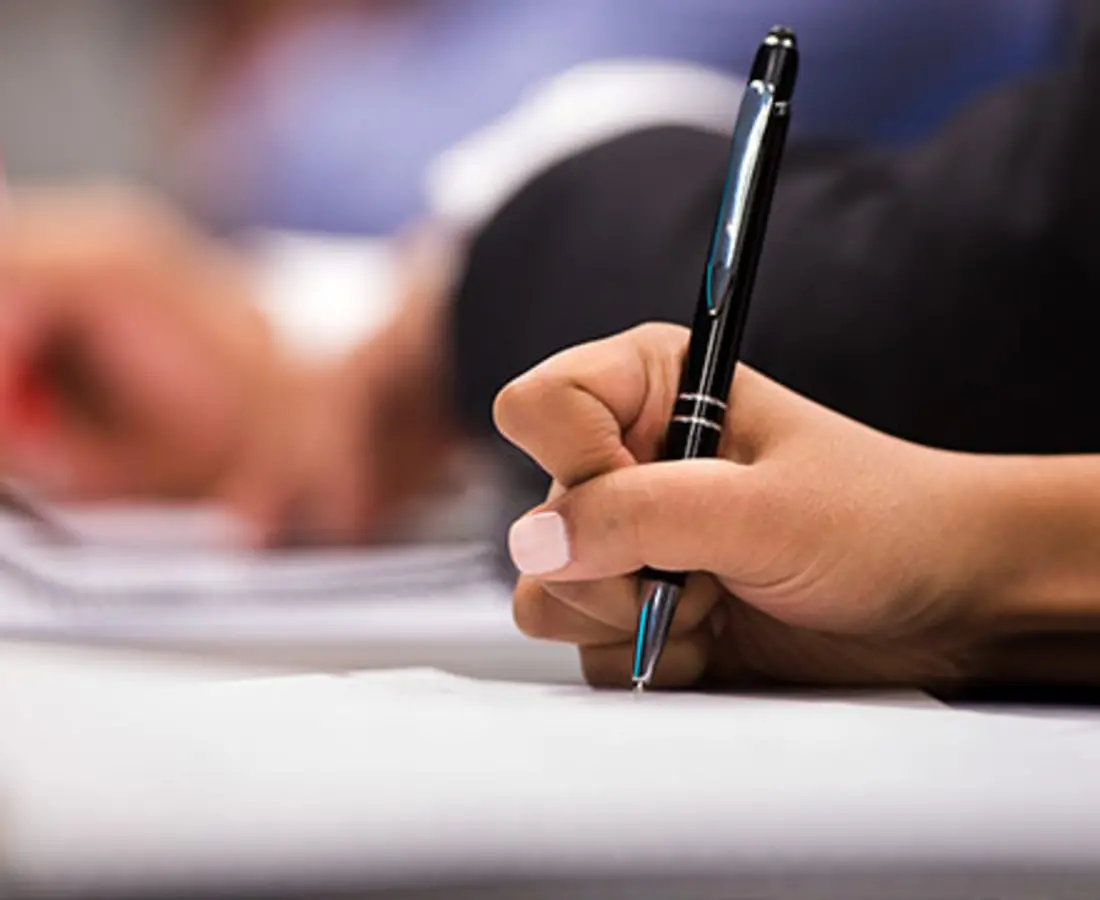 Student writes in class