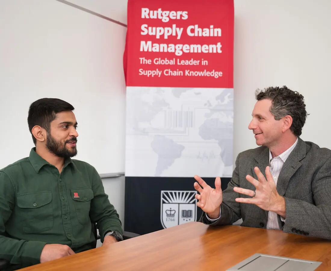 student speaking with a professor about graduate program