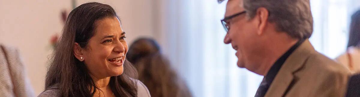 image of two people talking at the alumni awards ceremony