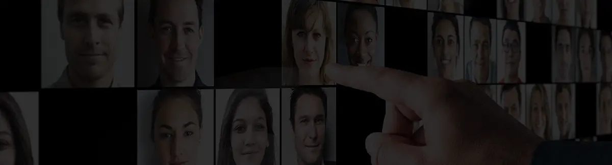 finger pointing at image of people on screen