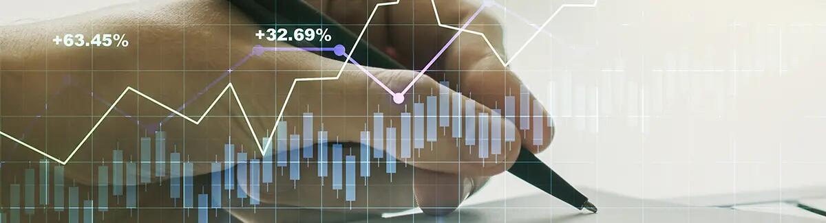 financial graph overlaying a hand writing on paper