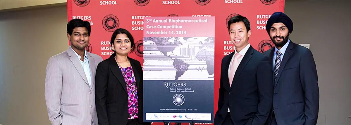 Members of the Rutgers Biopharmaceutical Case Competition team pose in front of the competition banner