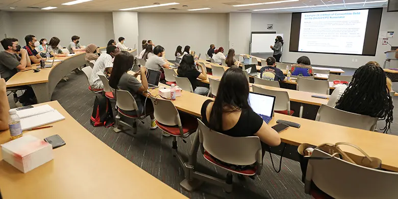 A classroom of students listen to a review of a calculation presented by Rutgers Business School accounting professor Joyce Joseph.