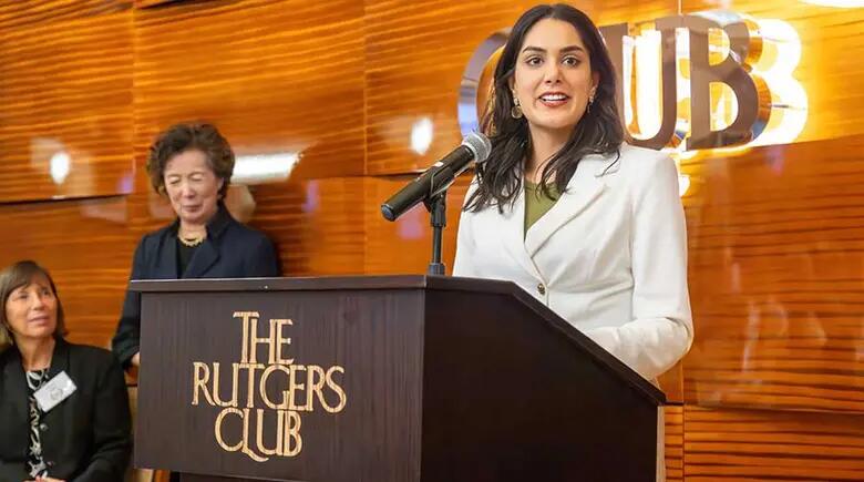 Alumna Aisha Khan making remarks during the awards dinner.