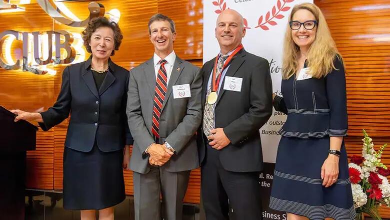 Award recipient Jeff Mraz poses with Rutgers Business School Dean Lei Lei, Sharon Lydon and Mark Anquillare, a 2023 award recipient.