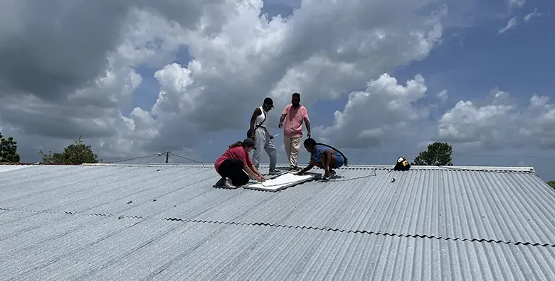 Rutgers University-Newark students helping to install solar panels in Belize.