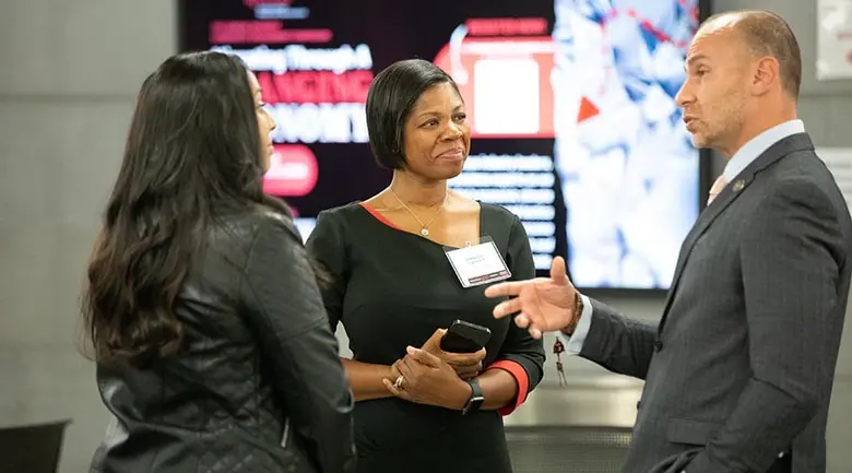 Attendees at the Business and Community Engagement Symposium networking at the start of the event.