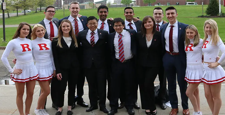 Cheerleaders and members of Little Investment Bankers of Rutgers escorted student investors Andrew Lee and Karn Dalal.