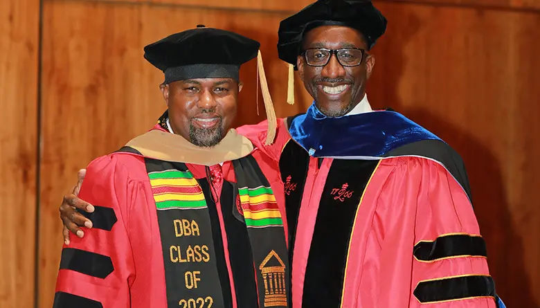 Jeffrey Robinson, provost and executive vice chancellor at Rutgers University-Newark with graduating Ph.D. student Hannibal Fleming.