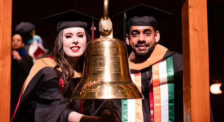 Two graduate students celebrate the end of Rutgers Business School's 2023 Graduate Program Convocation.