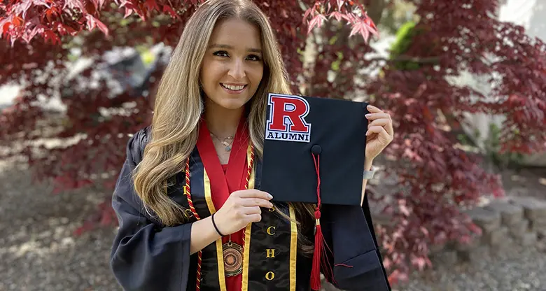Rutgers Business School graduating senior Anna Pisklarov borrowed a cap and gown to take photographs.