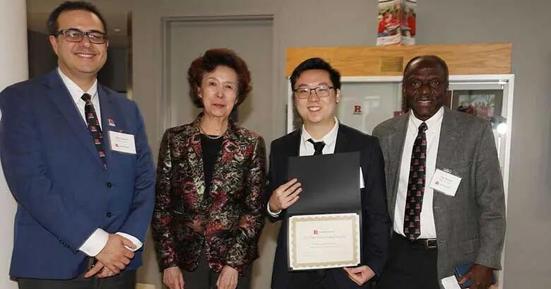 Senior accounting student Kevin Cheung stands with Rutgers Business School Dean Lei Lei and two associate deans.