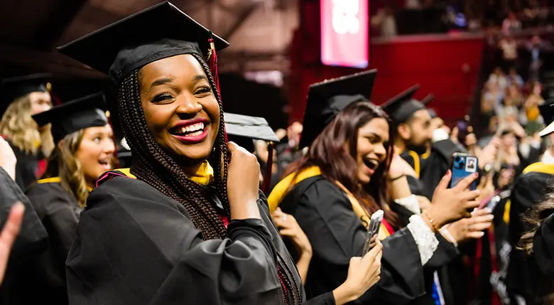 Graduates of Rutgers Business School-New Brunswick are jubilant after the tradition of turning the tassel.