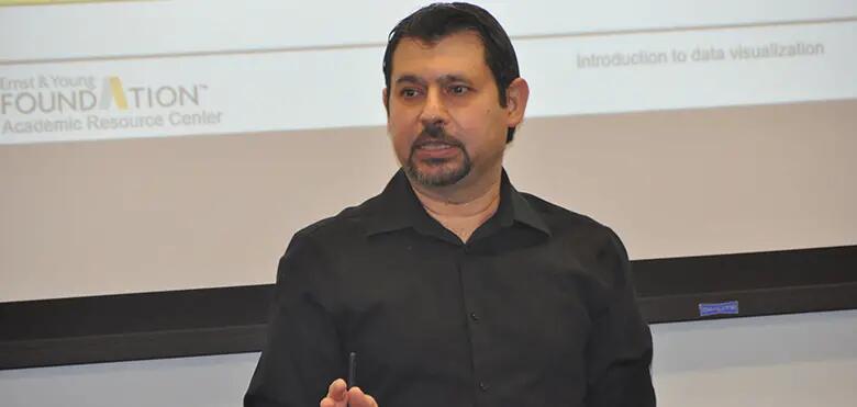 Photo shows Professor Hussein Issa in a classroom at Rutgers Business School-New Brunswick.
