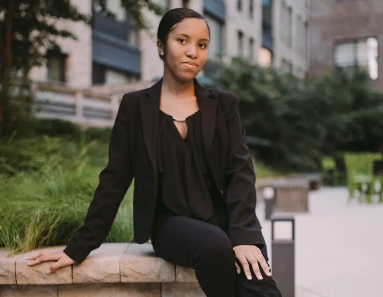 Graduating Rutgers Business School student Krystal Williams posing for a photograph on campus.