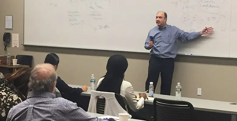 Professor & Executive MBA Program Director Farrokh Langdana gives a macroeconomics overview to Rutgers Executive MBA students’ spouses.