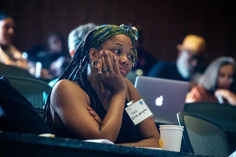 Conference participant listens to a discussion.