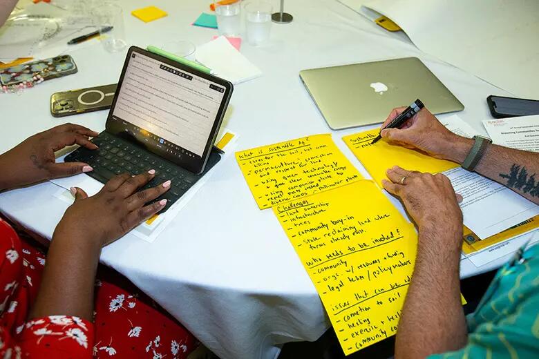 Photo shows the work of two conference participants in a roundtable discussion.