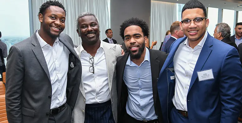 A group of Rutgers Business School alumni posing for the camera.