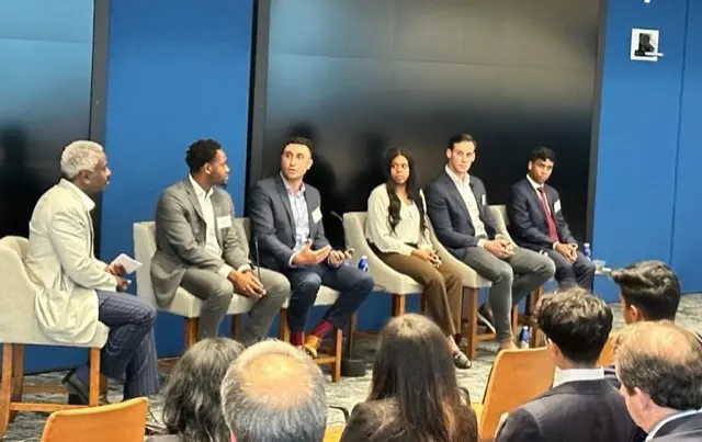 A group of Road to Wall Street alumni participate in a panel discussion.