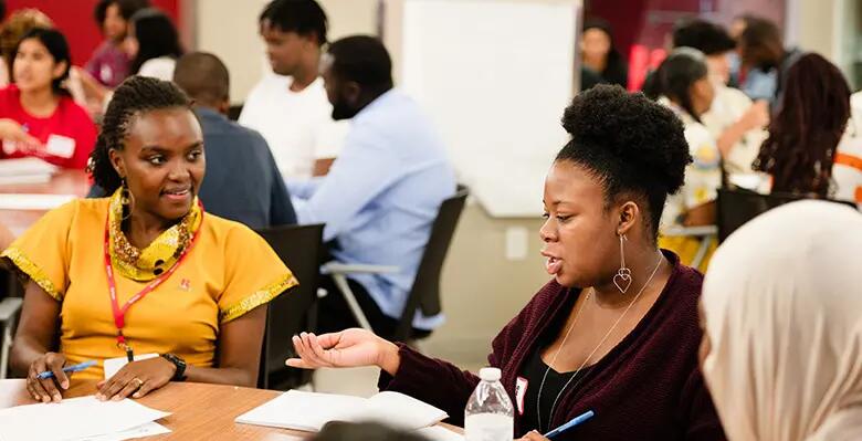 A team of students in the summer supply chain program work alongside Etta Madete, one of the Mandela Washington Fellows.