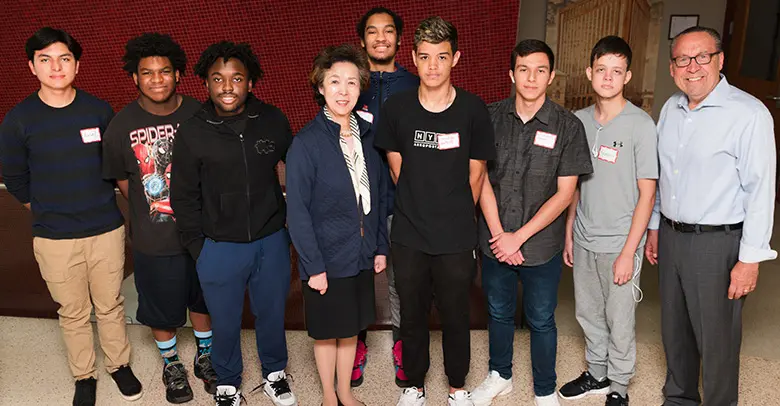 Rutgers Business School Dean Lei Lei poses with students from Newark's Hillside High School.