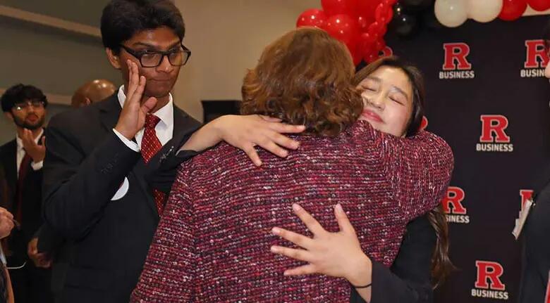 A student from Team RU360 embraces RBS faculty member Mary Giordano, the team's mentor.