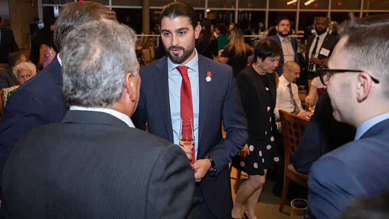Alumnus Amir Ismail speaks with other award recipients during the dinner.