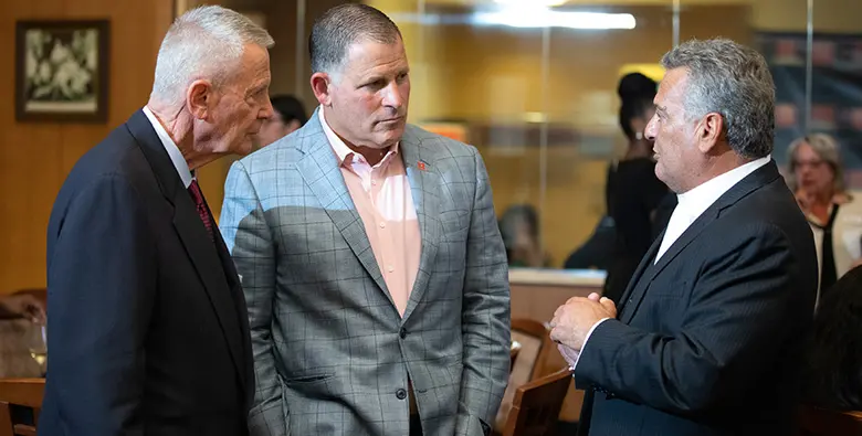 Rutgers football coach Greg Schiano with Rutgers alumni John Herma and Art Certosimo.