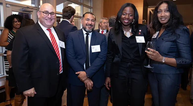 Rutgers Executive MBA alumna Ukachi Anonyuo is shown with other guests.