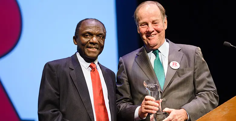 Former Gov. Thomas Kean receives a "hero" award from Rutgers Business School Executive Vice Dean Yaw Mensah.