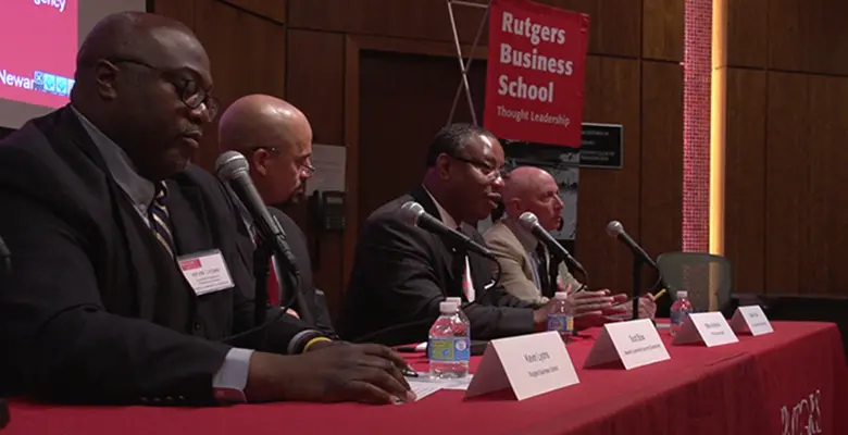 Professor Kevin Lyons takes notes during a panel presentation.