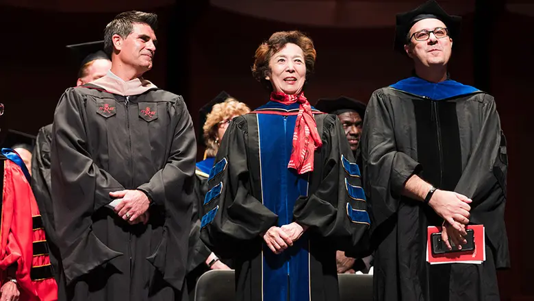Rutgers Business School Dean Lei Lei stands with convocation speaker Jeffrey Hermann at the graduate program convocation ceremony.