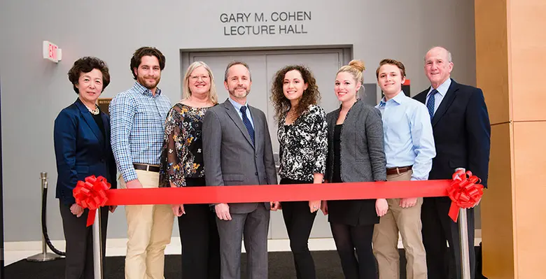 Rutgers MBA alumnus Gary M. Cohen stands with his family, Dean Lei and Rutgers University President Robert Barchi.