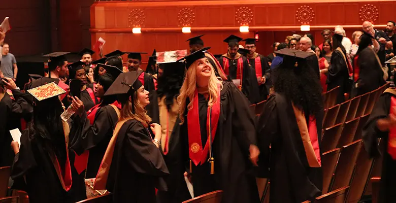 Graduates search New Jersey Performing Arts Center for family and friends.