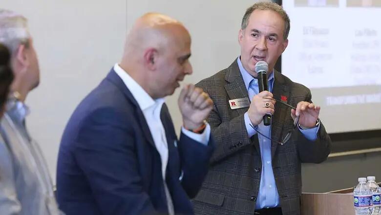 Moderator Phil Cohn poses a question to a panel of professionals.