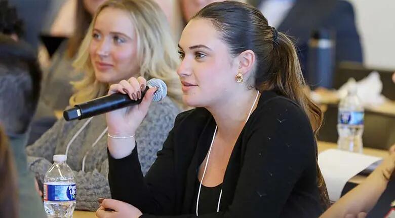 A student asks a question during the marketing summit.