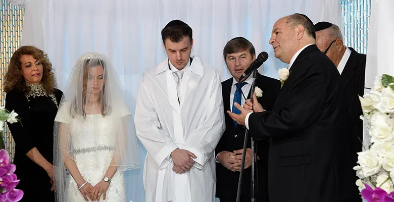 Mitchell Novitsky volunteers as a rabbi, performing a marriage.