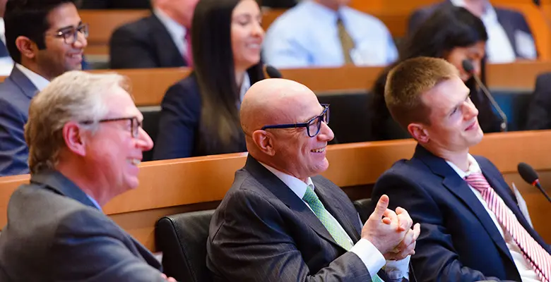 Sopranzetti (center) said that Dirla was a "rare gem," who has shown an "exemplary dedication to helping students at all levels find jobs on Wall Street."