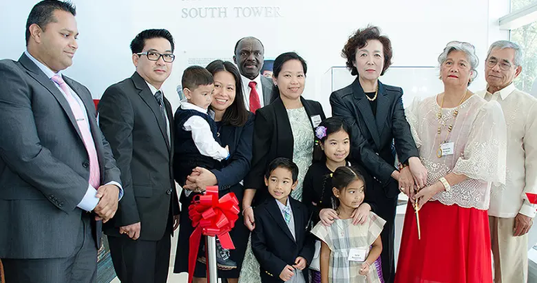 The De Chavez family, including Jayceryll's sisters and their families, pose with Rutgers Business School administrators.