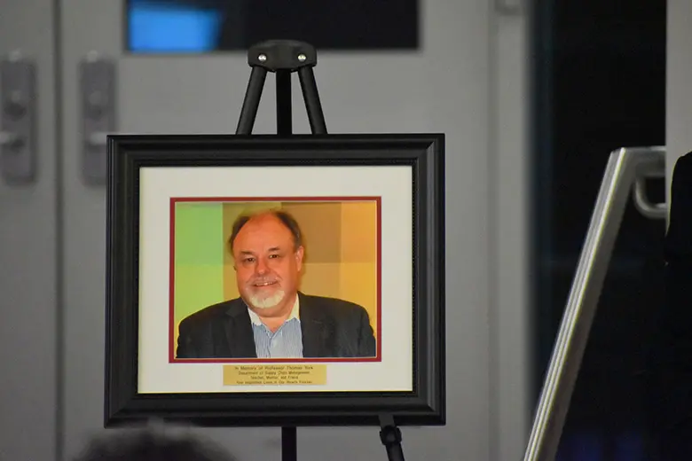 Professor Thomas York is honored with a plaque by Rutgers Business School faculty, students and alumni.