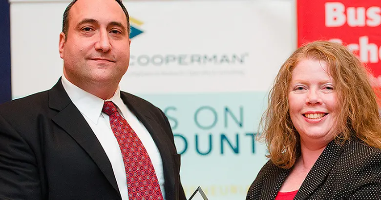 Veteran Eric Kropiwnicki, who completed the Rutgers Business School Executive Education Mini-MBA: Business Management for Military and Veterans, is honored for his leadership by Margaret O'Donnell, manager of Military and Veteran Engagement Programs at Rutgers Business School.