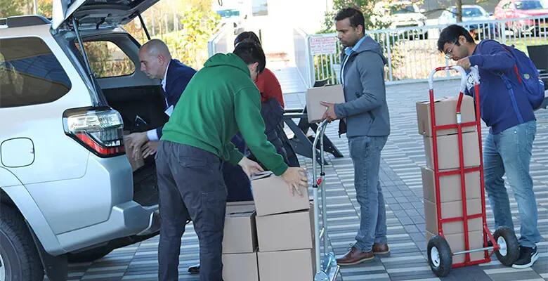 Students loaded food boxes for delivery.