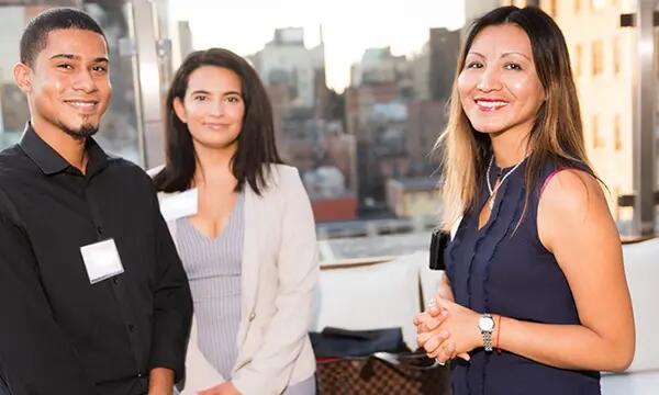one male and two female students attending a happy hour event