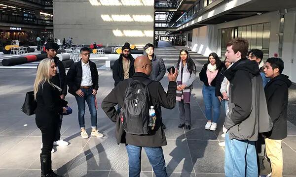 alumni speaking with students inside company lobby