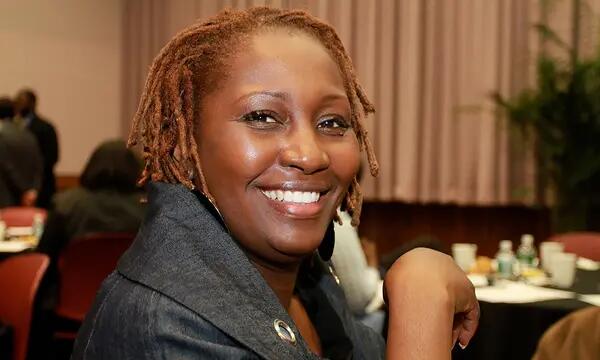 Closeup shot of a woman smiling for the camera at a CUEED event